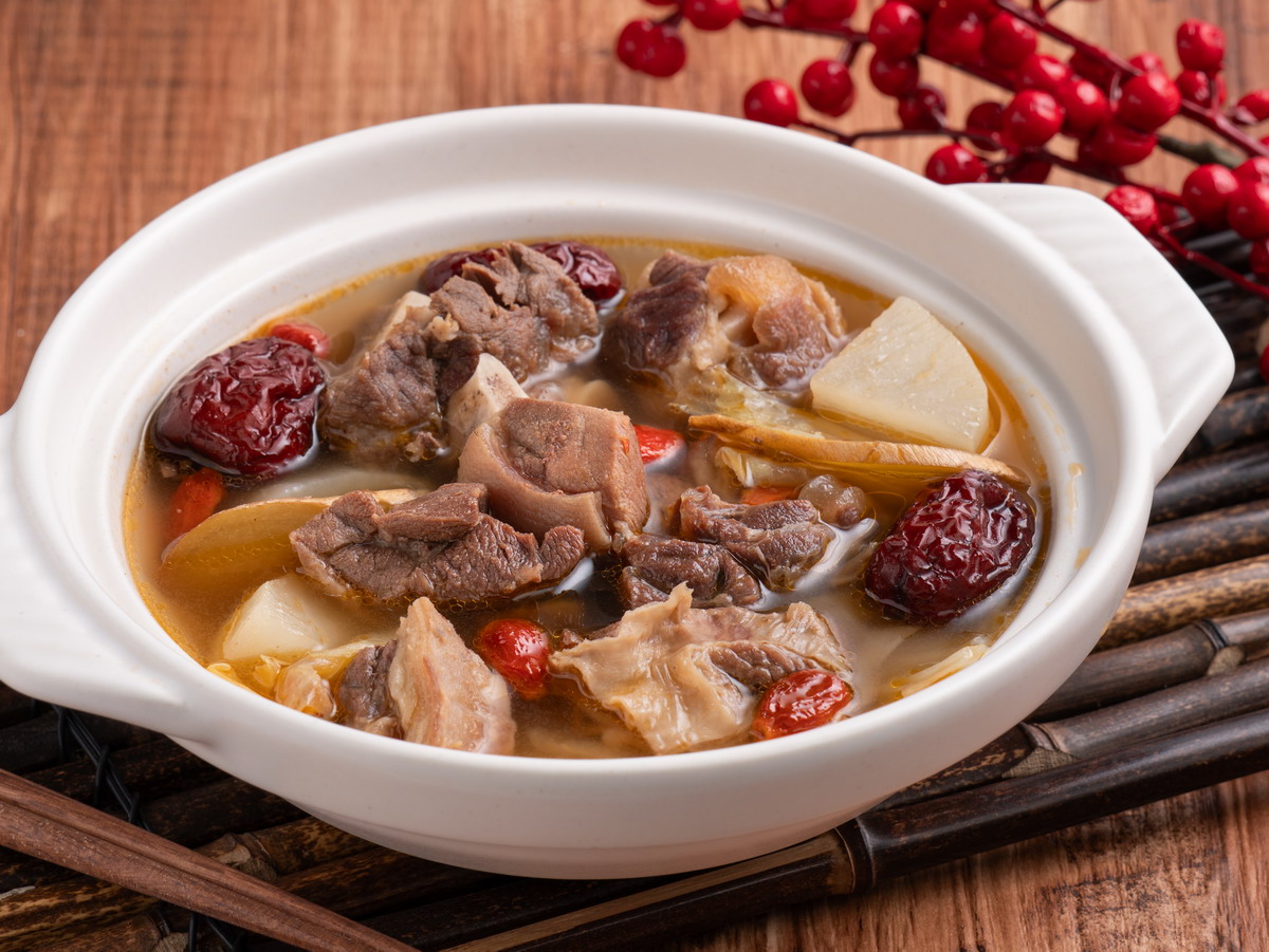 traditional chinese medicinal mutton hot pot with herbs white bowlOWEB